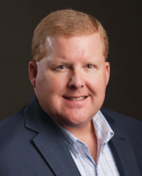 Smiling man in suit and collared shirt