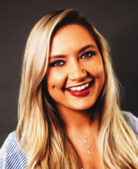 Smiling woman with long blonde hair.