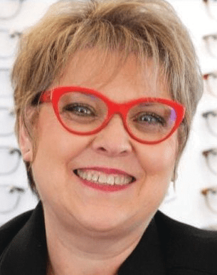 Spring-River-Area-Chamber-Guide-2024_page_9_29 Smiling woman with red glasses in optician's office.