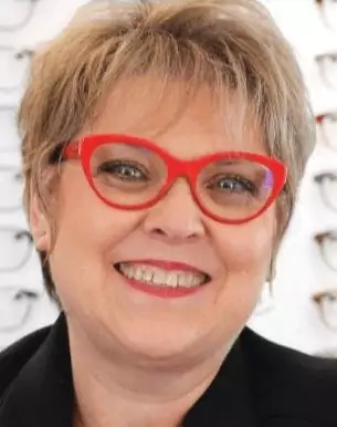 Spring-River-Area-Chamber-Guide-2024_page_9_29 Smiling woman with red glasses in optician's office.
