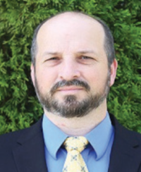 Man in suit with green plant background