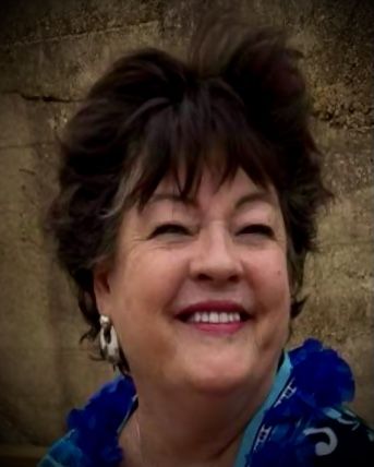 kari hollis Smiling person in blue near wall